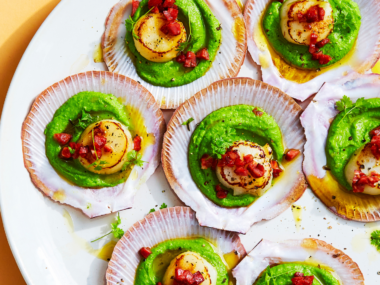 Several scallops served in their shells with Champagne and green pea sauce.