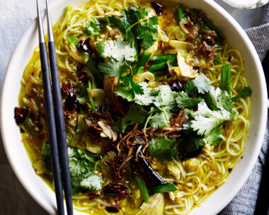 Bowl filled with our best chicken noodle soup recipe topped with fried shallots and coriander leaves