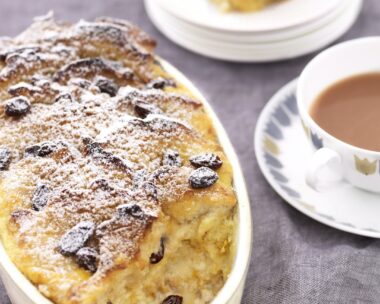 Classic bread and butter pudding, served with a cup of tea for traditional British comfort.