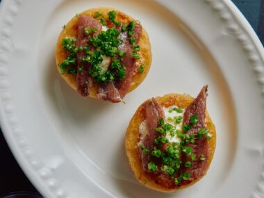 Close-up of anchovies with smoked butter and chives on crumpets from the refreshed menu at the Prince Dining Room.